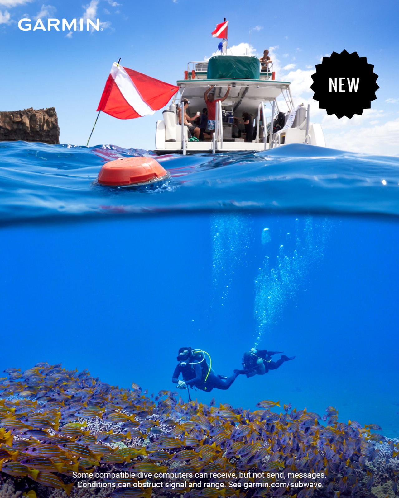 Over-under view of a dive boat flying the dive flag with a Garmin Descent buoy floating at the surface, and two scuba divers exploring a coral reef below.
